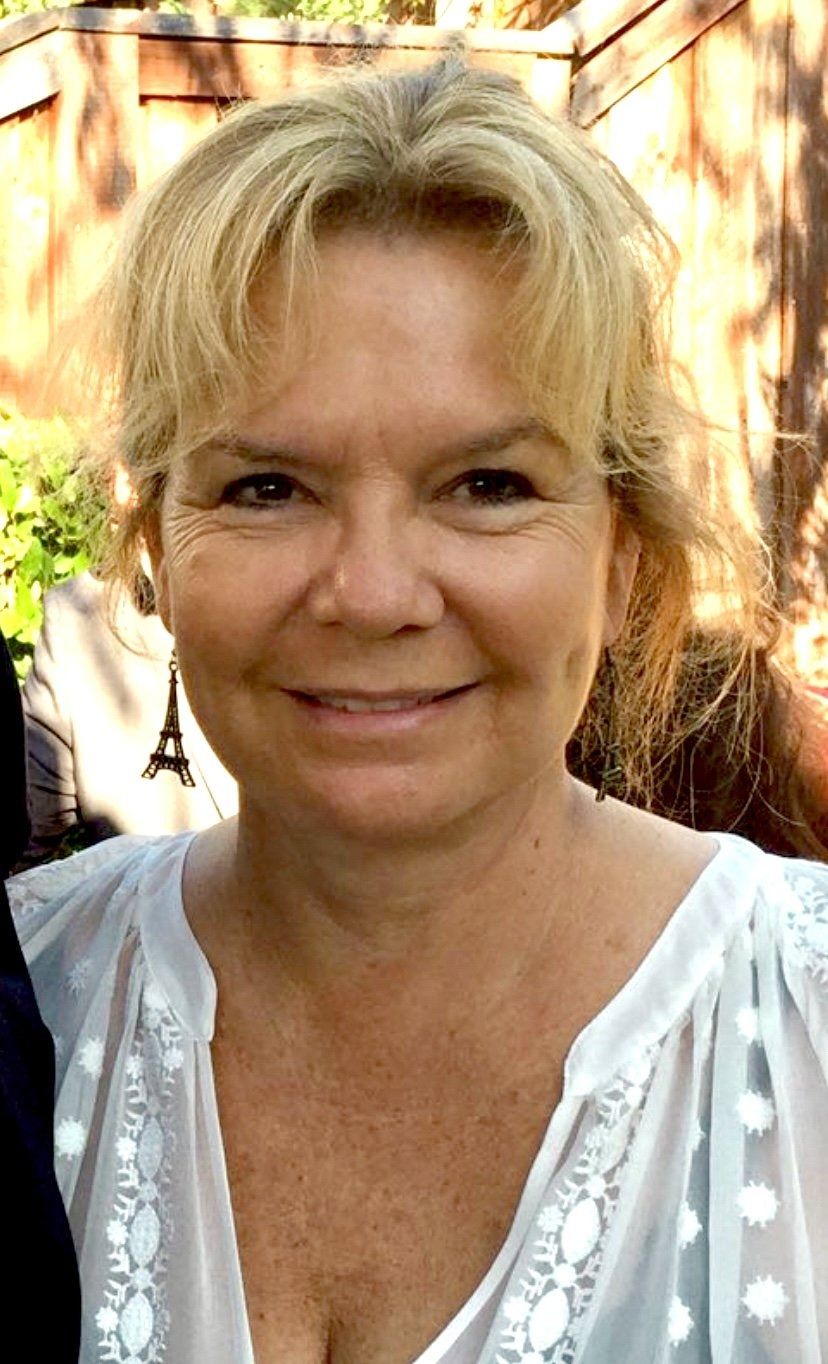 Portrait of author Leslie Johansen Nack smiling outdoors.