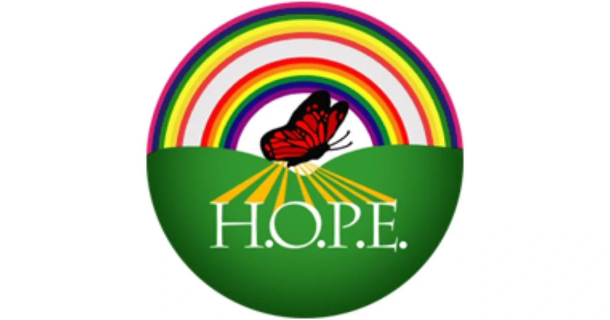 A circular logo featuring a rainbow over green hills, a red butterfly in the center, and the word H.O.P.E. written in white letters.