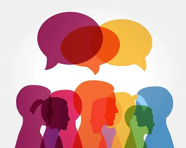 A group of overlapping, colorful silhouettes of people’s heads beneath several semi-transparent speech bubbles.