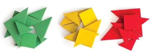 Three piles of plastic geometric shapes in green, yellow, and red.