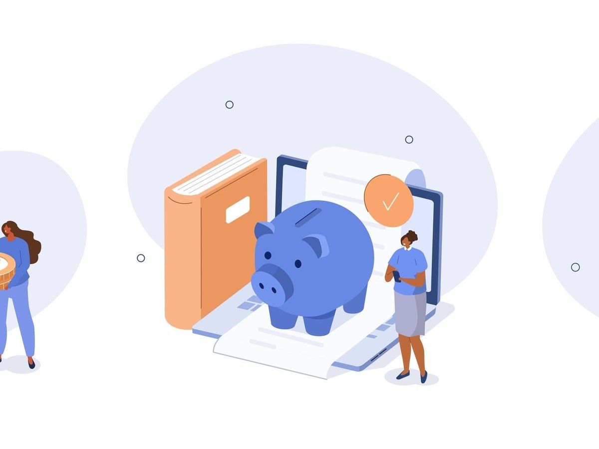 A blue piggy bank sits on a laptop next to a book and a document with a checkmark, with a person standing nearby.
