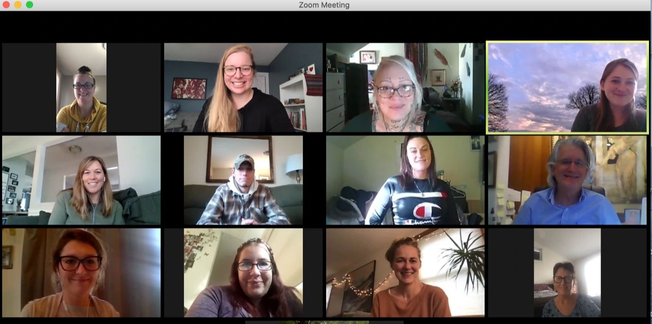 A Zoom meeting grid showing eleven participants in individual video frames.