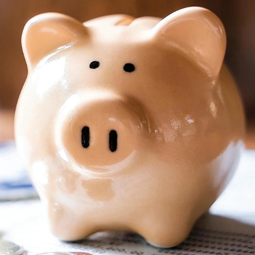 Pink ceramic piggy bank with black eyes and nostrils sitting on newspaper.